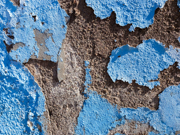 istock Weathered cement wall with peeling paint. Abstract grunge background. Old damaged concrete cement wall with flaking blue paint. 1817250873
