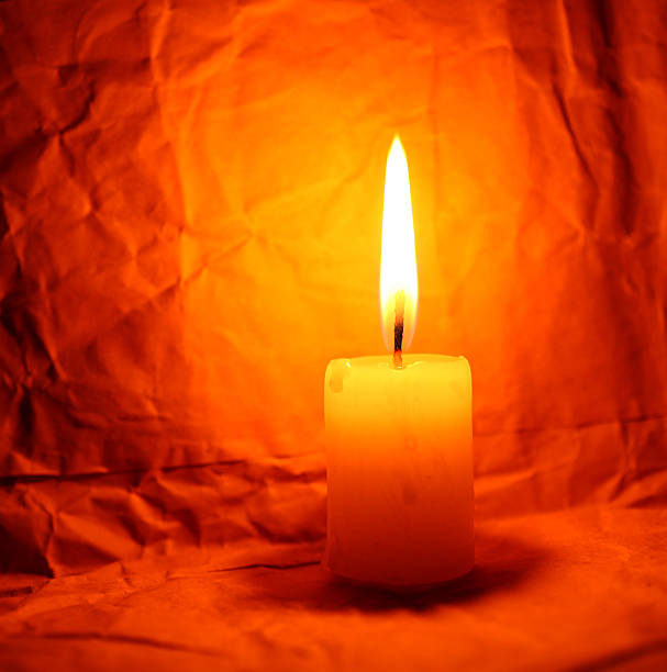 Candle Close up of Candle with red background Aflame stock pictures, royalty-free photos & images