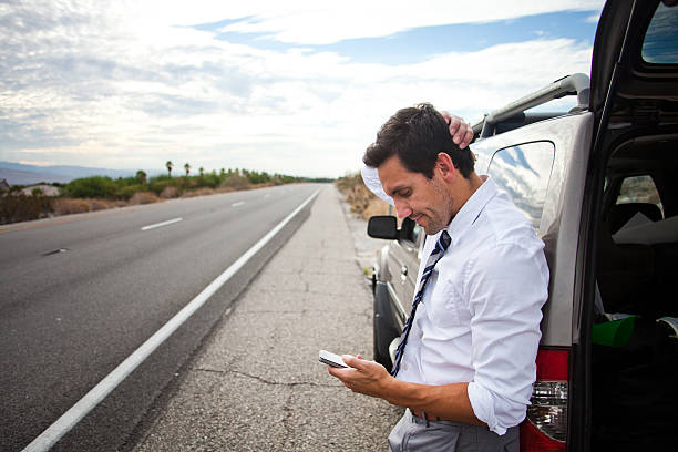 istock Man stuck in desert with car broken down 181728605