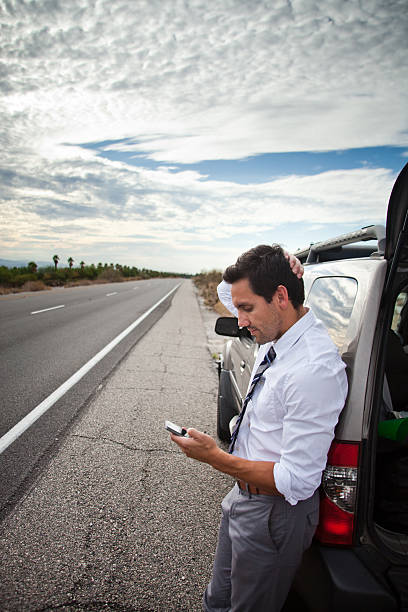 istock Man stuck in desert with car broken down 181728611