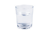 A simple glass half full of fresh crystal clear mineral water, object isolated on white background, cut out, front view. Hydration, drinking water daily intake abstract concept, nobody