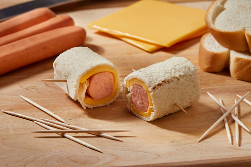 Preparing Mini Grilled Cheese Hot dog Rolls. Made with Processed cheese slices and flattened White Bread