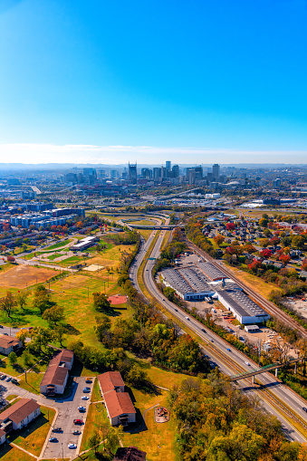 A Nashville area highway leading toward the skyline of downtown through the suburbs shot via helicopter from an altitude of about 800 feet.