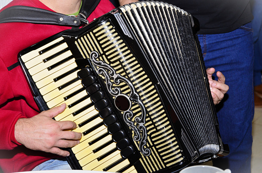 Beautiful accordion musical instrument being played at party