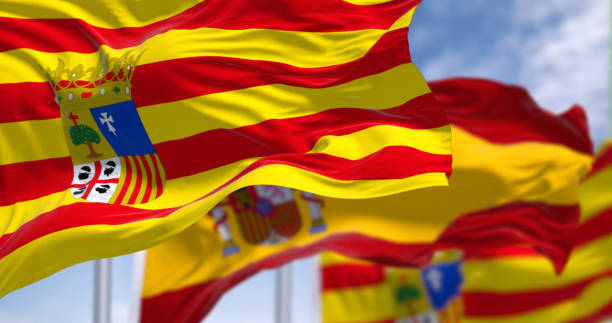 Aragon flag and Spanish flag waving in the wind