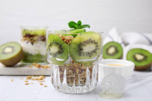 istock Delicious dessert with kiwi and muesli on white table, closeup 1817358228