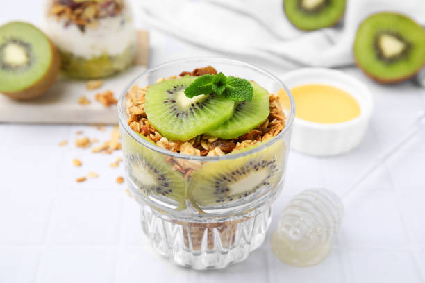 istock Delicious dessert with kiwi and muesli on white table, closeup 1817358758