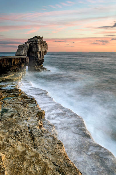 Pulpit Rock Sunset A stunning autumn sunset at Pulpit rock on the Isle of Portland with the full force of the English Channel crashing against the rocks. bill of portland stock pictures, royalty-free photos & images