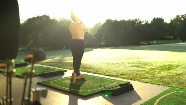 Sun illuminating a woman playing golf in a court
