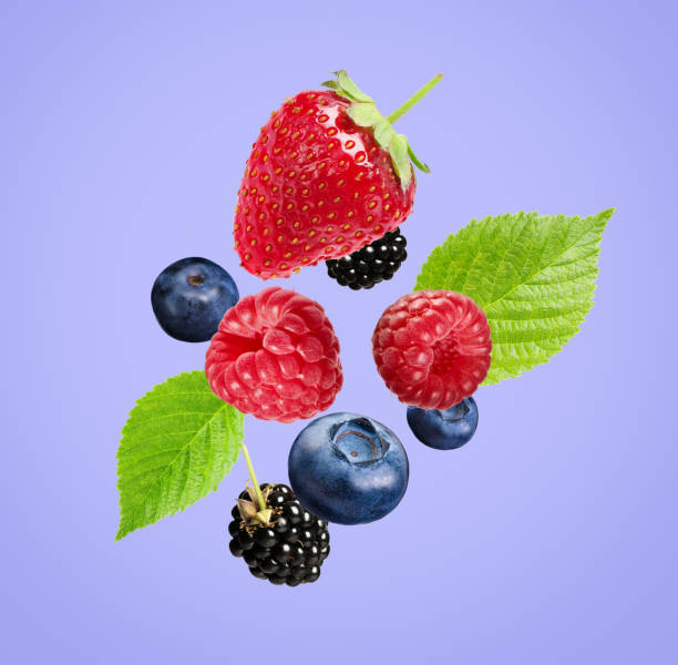 istock Many different fresh berries falling on light slate blue color background 1817403928