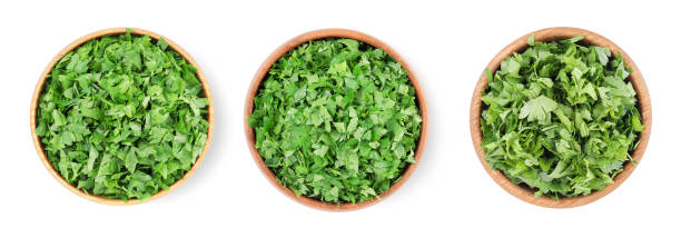 istock Set with cut parsley in bowls isolated on white, top view 1817411950