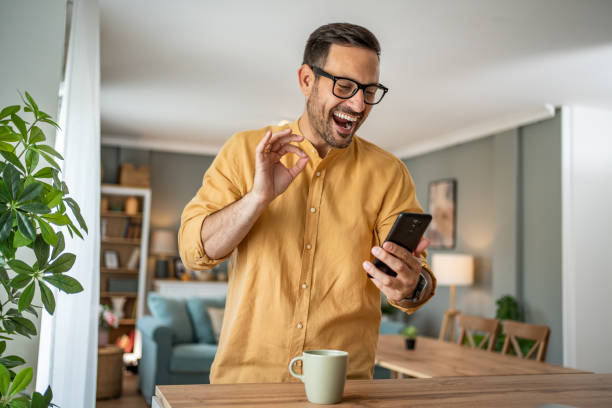 istock Handsome middle-aged Caucasian man taking a selfie or making a video call at home in his living room using a mobile phone 1817430890