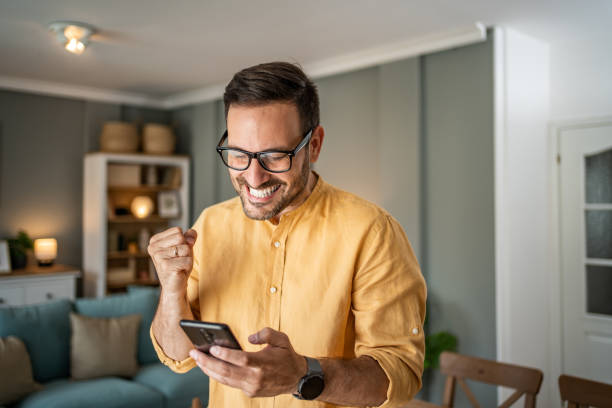 istock Handsome middle-aged Caucasian man taking a selfie or making a video call at home in his living room using a mobile phone 1817430908