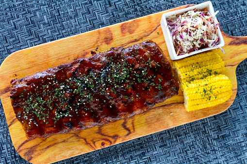 Rack of Pork Ribs with Barbeque Sauce, corn cob and coleslaw