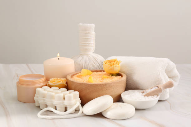istock Sea salt, different spa products and beautiful rose on white marble table 1817445428
