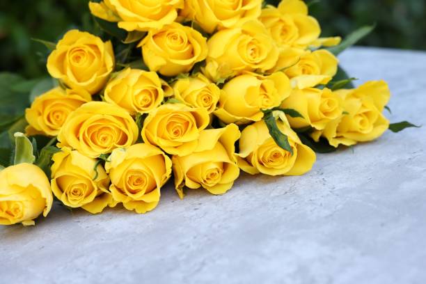 istock Beautiful bouquet of yellow roses on light table 1817463538