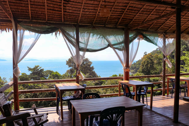 熱帯の島にある木製のテラス付きのカフェ - 海の景色。旅行、リラクゼーション、休暇のコンセプト。