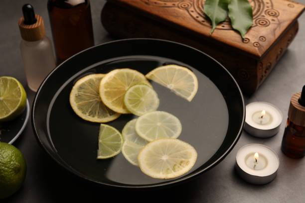istock Bowl of essential oil with lemons on grey table. Aromatherapy treatment 1817472504