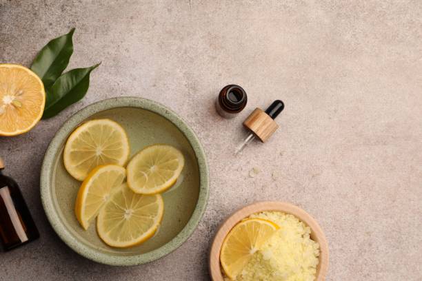 istock Flat lay composition with essential oil and lemons on grey textured table, space for text. Aromatherapy treatment 1817472505