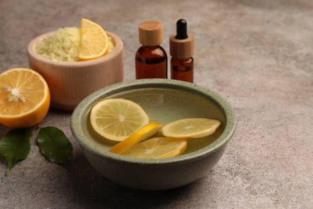 istock Essential oil with lemons and sea salt on grey textured table. Aromatherapy treatment 1817472506