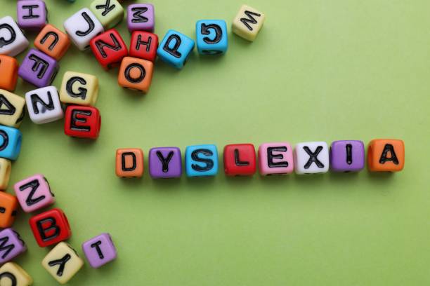 istock Colorful beads with word Dyslexia on light green background, flat lay 1817509158