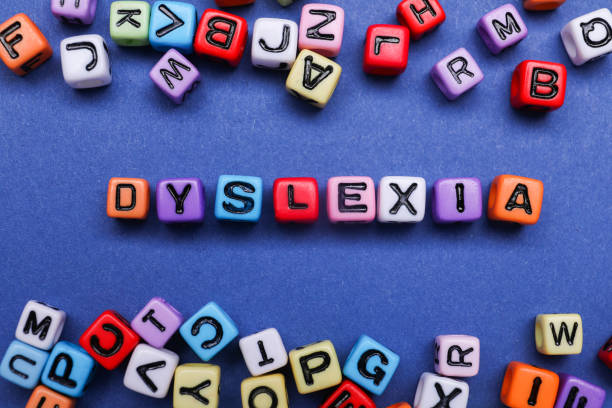 istock Colorful beads with word Dyslexia on blue background, flat lay 1817510416