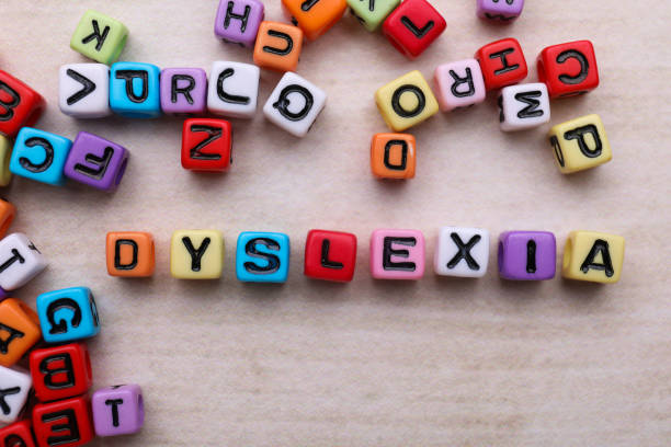 istock Colorful beads with word Dyslexia on light table, flat lay 1817511462