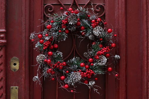 Beautiful Christmas wreath hanging on red door