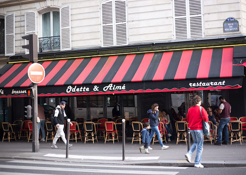 Paris, France: Pedestrians walk past Odette & Aimé, a cafe-brasserie on Rue de Maubeuge in the 9th arrondissement.