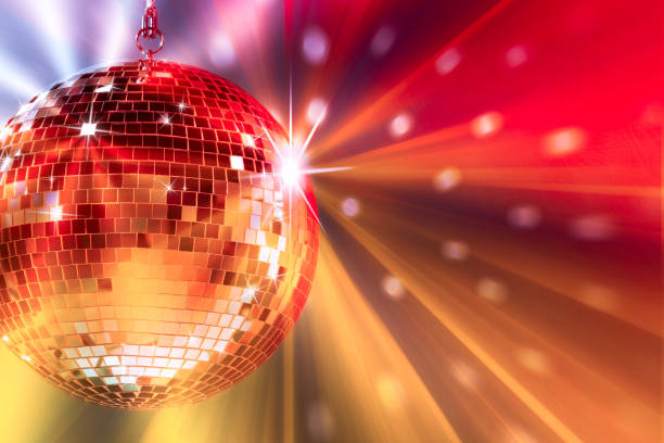 istock Shiny bright disco ball under color lights, space for text 1817520710