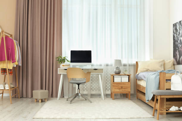 istock Stylish teenager's room interior with computer and comfortable bed 1817525058