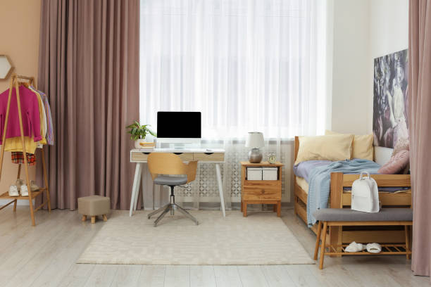 istock Stylish teenager's room interior with computer and comfortable bed 1817525607