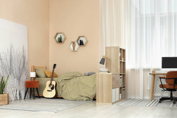 istock Stylish teenager's room interior with comfortable bed and workplace 1817526134