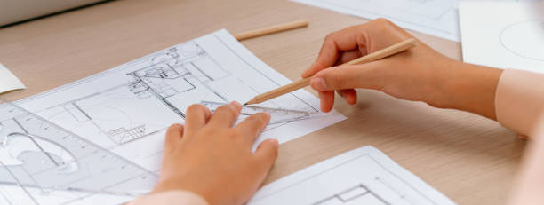 istock Professional architect hand drawing a blueprint on table. Closeup. Delineation. 1817560318