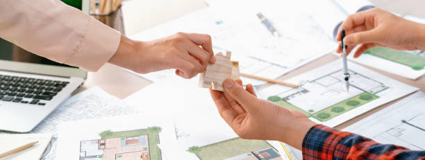 istock Profession engineer and architect collaborate on eco house project. Delineation. 1817560908
