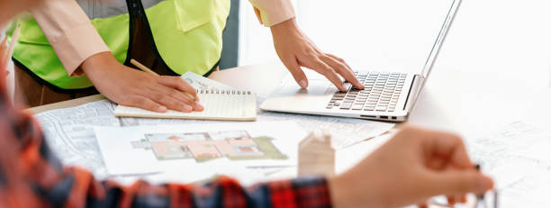 istock Cropped image of professional engineer team working on blueprint. Delineation. 1817561978