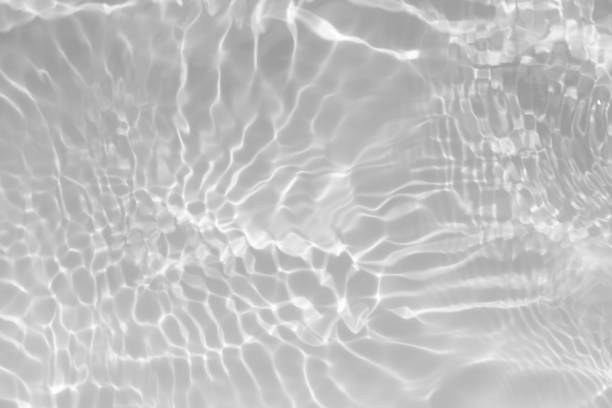 istock White water with ripples on the surface. Defocus blurred transparent white colored clear calm water surface texture with splashes and bubbles. Water waves with shining pattern texture background. 1817566232