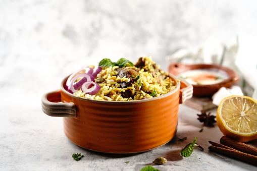 Homemade Chicken Dum biryani | Malabar Irachi choru served with Yogurt salad, selective focus