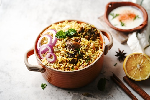 Homemade Chicken Dum biryani | Malabar Irachi choru served with Yogurt salad, selective focus