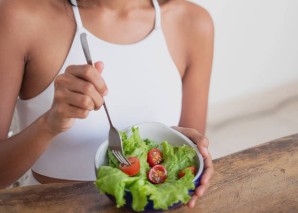 istock Unrecognizable Woman Eating Simple Green Salad 1817571969