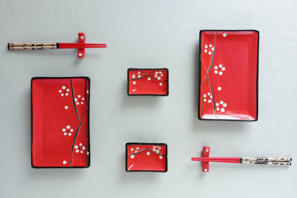 istock Red ceramic set of plates for sushi and rolls on a gray background. View from above. 1817581669