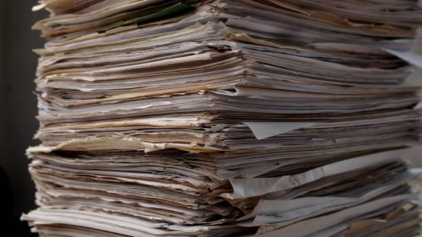 istock Stack business paper on desk, paperwork in office. Piled heap high documents folders 1817609716