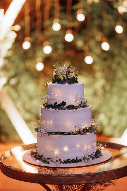 istock Wedding cake with flowers and greenery on arch 1817616431