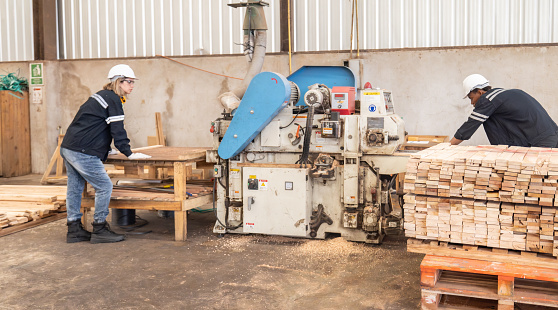 Wood turners operate a controller machine while tending a lathe to cut, shape, spin, polish, and balance wood and timber fixtures based on dimensions and needs. in the manufacturing process of wood.