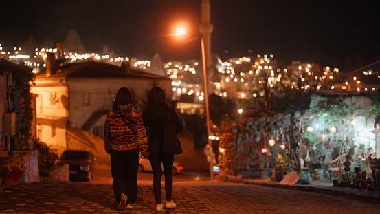 Two female tourists are walking and exploring the city in Cappadocia in Türkiye Turkey.