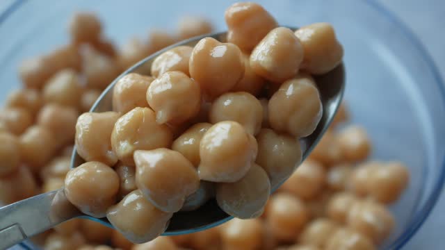 Boiled chickpeas on a spoon closeup