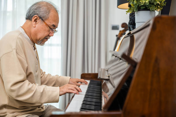 istock Asian senior retired man learning to play piano at home 1817752851