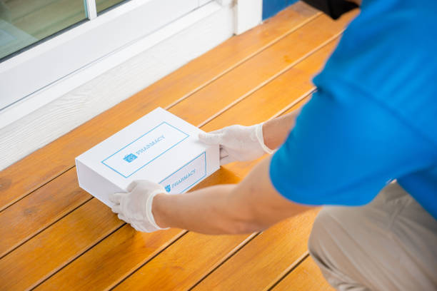 istock Delivery hands with gloves transport holding medication package box first aid shipment 1817755493
