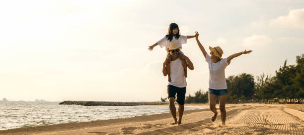 istock Happy family people having fun in summer vacation run on beach 1817756025