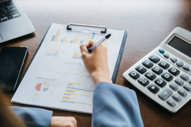 istock businesswoman working with paperwork charts and graphs and calculator 1817756033